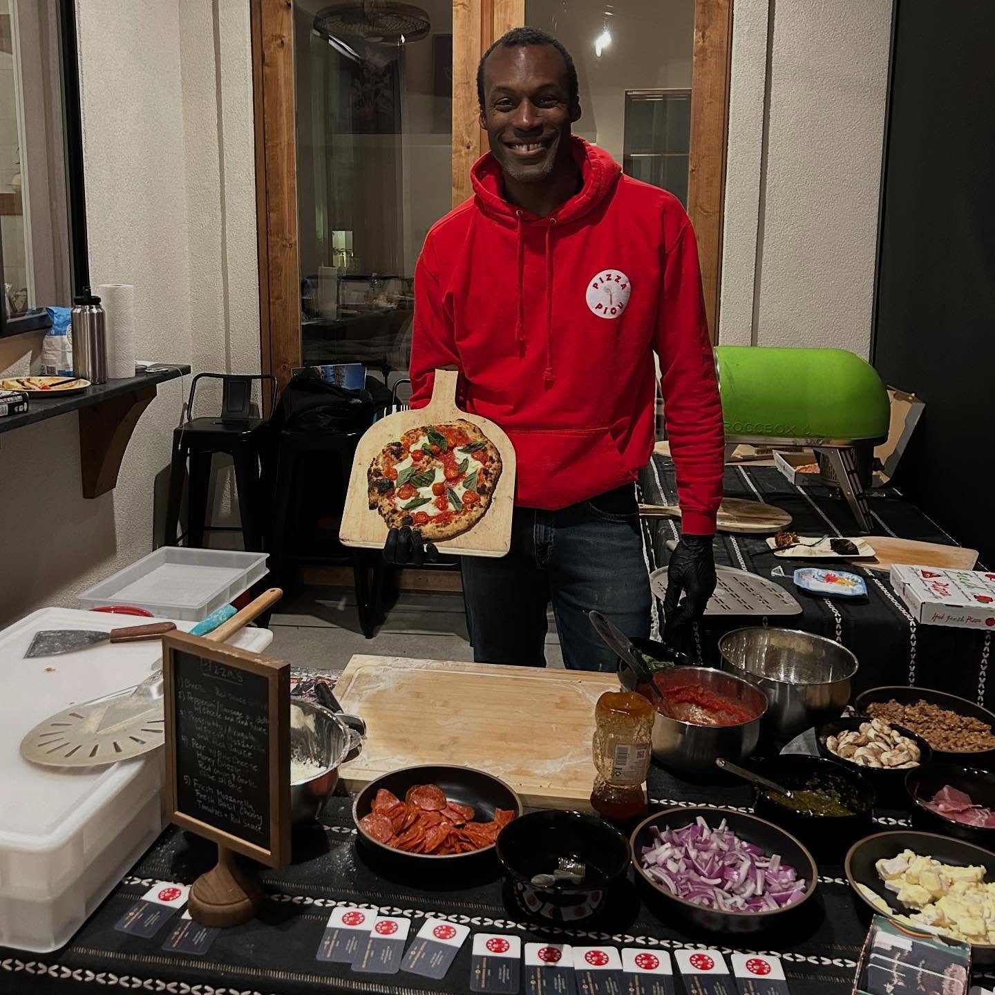 JP holding fresh Margherita pizza