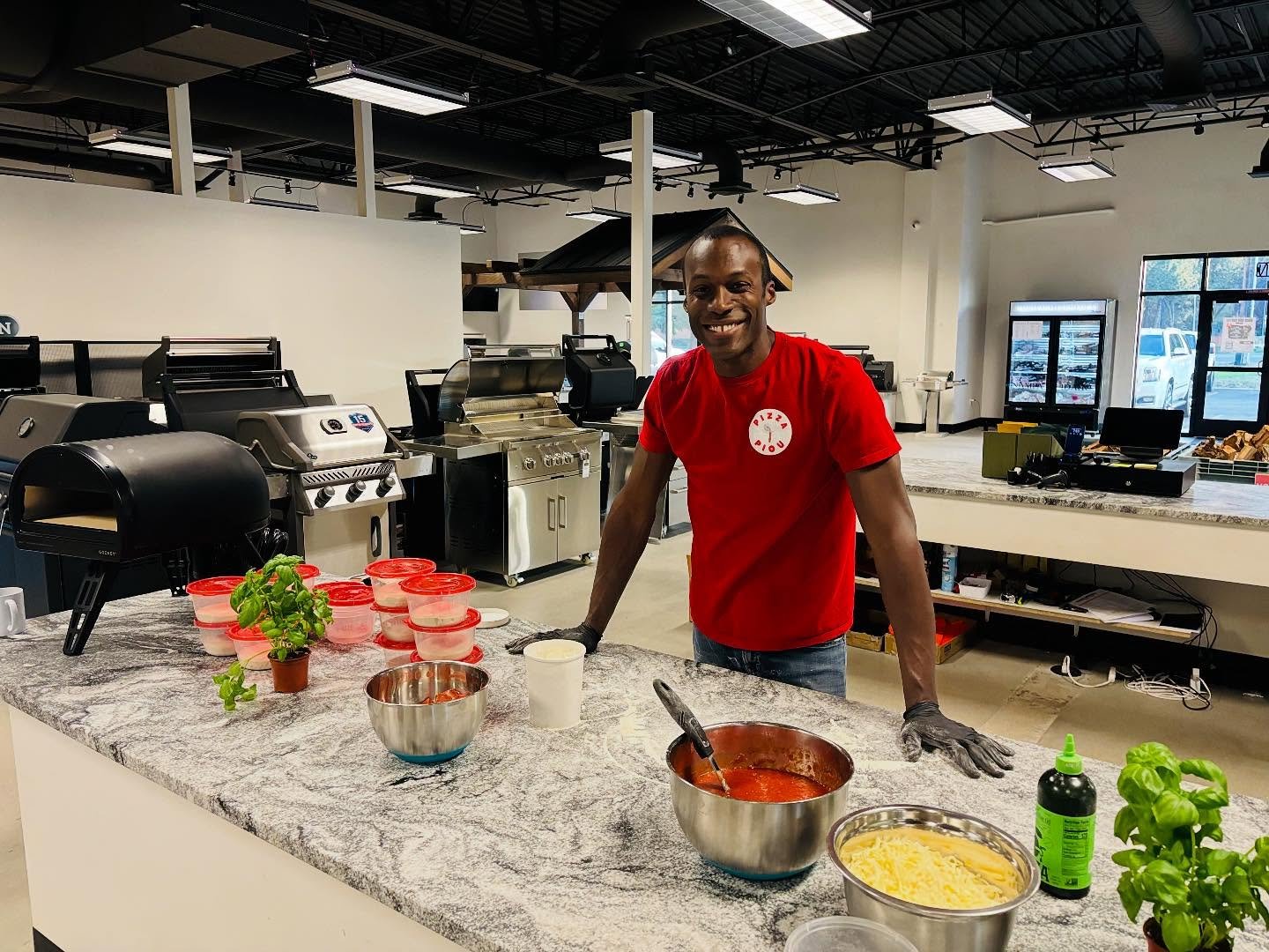 Jean-Pierre holding a fresh Margherita pizza